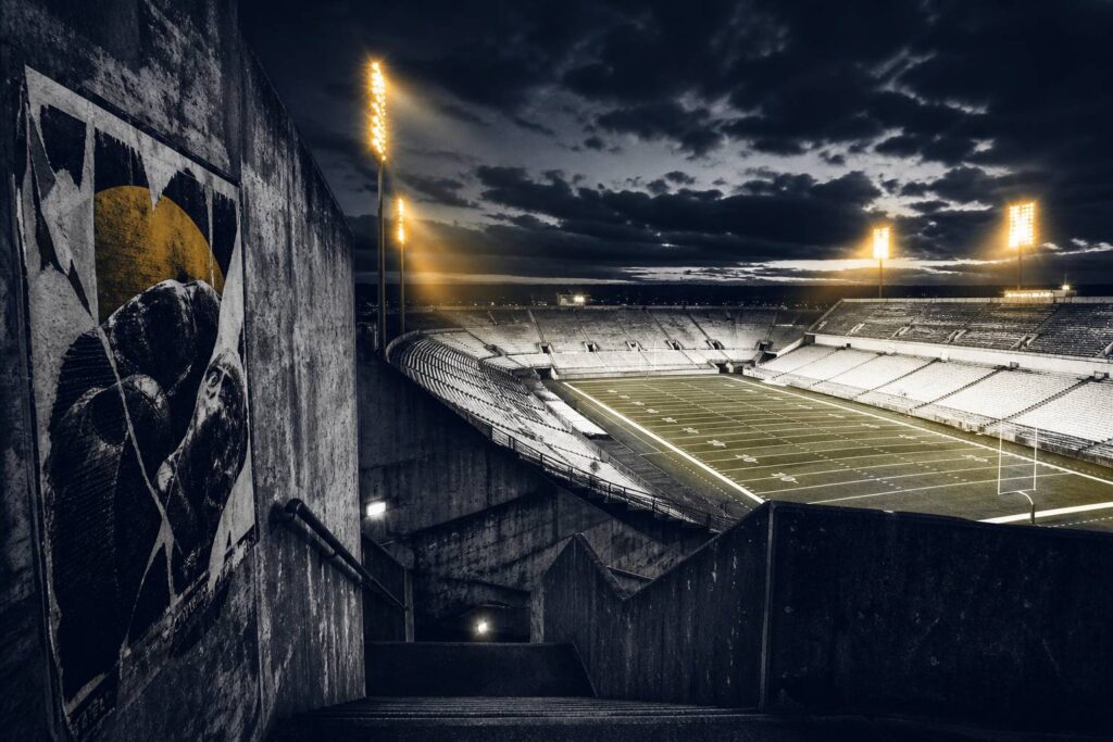 Grand stade américain en soirée avec projecteurs jaunes